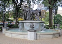 a statue of a man riding a horse in a park